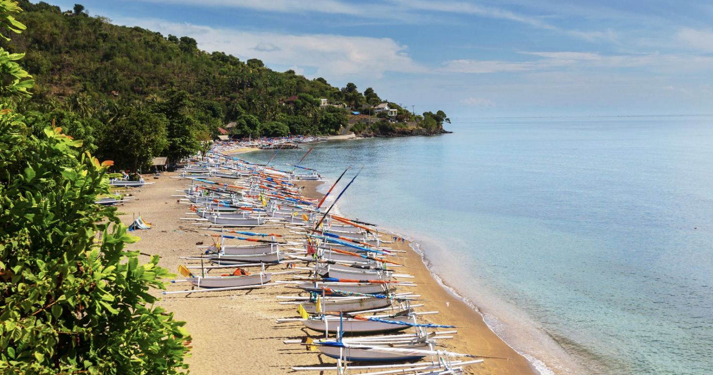 Amed Beach black sand coastline and Mount Agung Bali